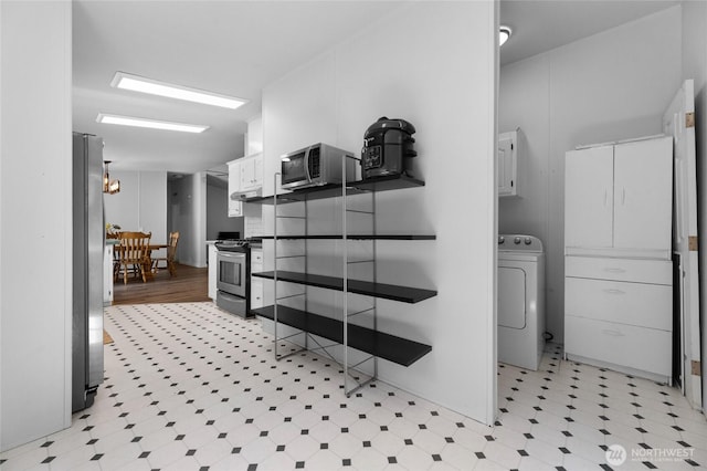 16037 Vail Loop Rd SE, Rainier, WA 98576 - bathroom with washer / clothes dryer and tile patterned floors