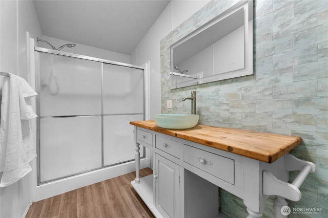 16037 Vail Loop Rd SE, Rainier, WA 98576 - bathroom with a stall shower, wood finished floors, and vanity
