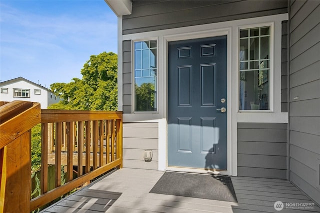 view of exterior entry with a deck