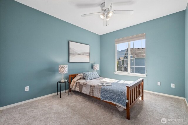 carpeted bedroom with baseboards and ceiling fan