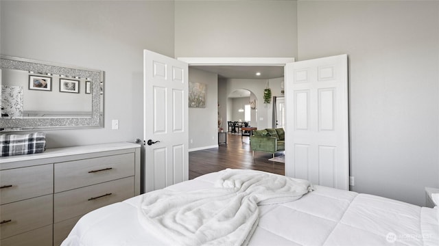 207 Clayton Pl, Mattawa, WA 99349 - bedroom with arched walkways, a towering ceiling, dark wood finished floors, and baseboards
