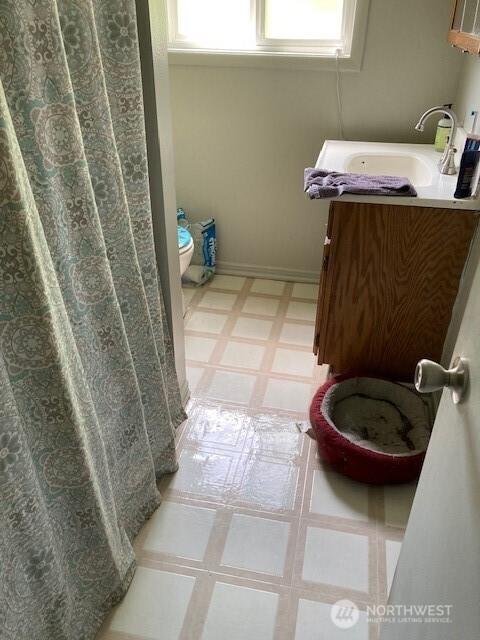 161 N Schoolhouse Hill Rd, Hoodsport, WA 98548 - full bathroom featuring tile patterned floors, toilet, and a sink