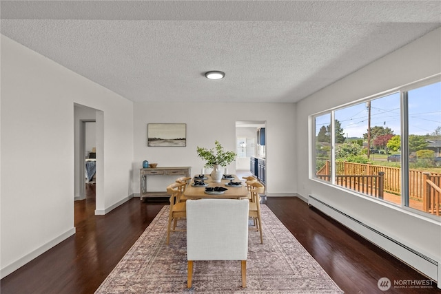 506 G St, Cosmopolis, WA 98537 - office space with a baseboard heating unit, dark wood finished floors, baseboards, and a textured ceiling