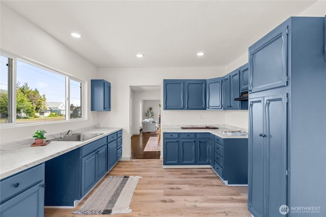 506 G St, Cosmopolis, WA 98537 - kitchen featuring a sink, blue cabinets, light wood-type flooring, recessed lighting, and light countertops