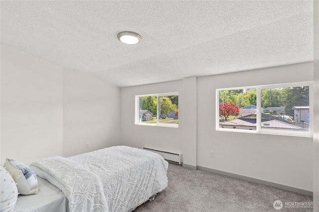 506 G St, Cosmopolis, WA 98537 - bedroom featuring a baseboard radiator, carpet floors, a textured ceiling, multiple windows, and baseboards