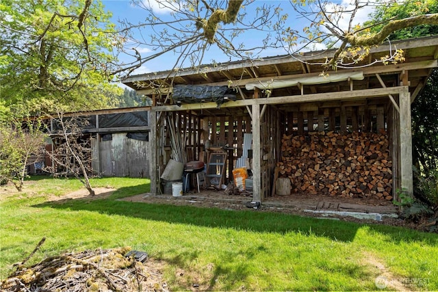 rear view of house with a lawn and an outbuilding