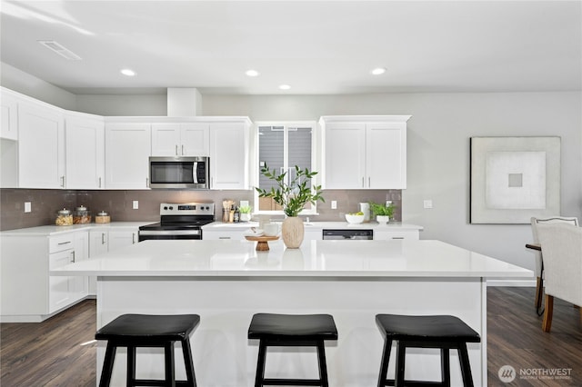 16636 8th Avenue Ct E Unit 05, Spanaway, WA 98387 - kitchen with appliances with stainless steel finishes, light countertops, white cabinets, and recessed lighting