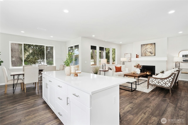 16636 8th Avenue Ct E Unit 05, Spanaway, WA 98387 - kitchen with dark wood-type flooring, a kitchen island, recessed lighting, white cabinets, and light countertops