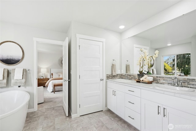 16636 8th Avenue Ct E Unit 05, Spanaway, WA 98387 - ensuite bathroom featuring a freestanding tub, recessed lighting, decorative backsplash, and double vanity