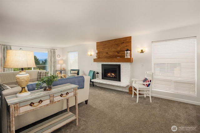 carpeted living area featuring a brick fireplace and baseboards