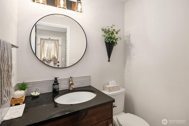 bathroom featuring toilet and vanity