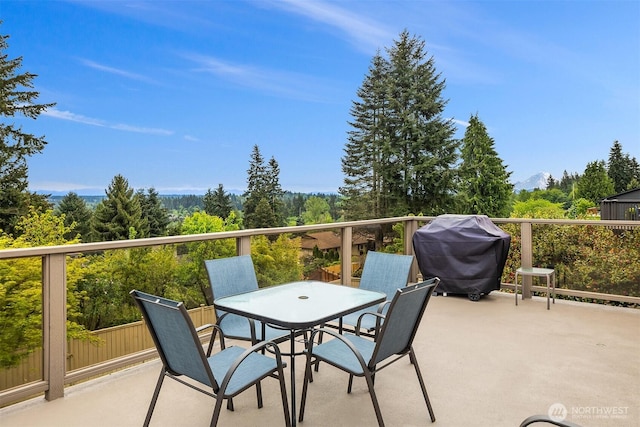 balcony featuring area for grilling and outdoor dining area