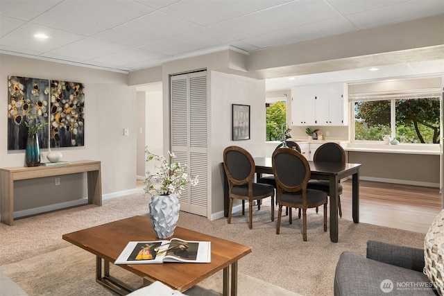 living room with baseboards, recessed lighting, and light carpet