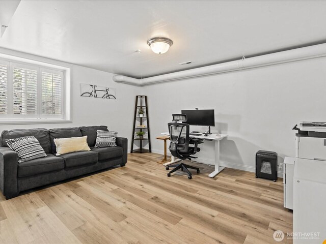 office space featuring light wood finished floors and baseboards