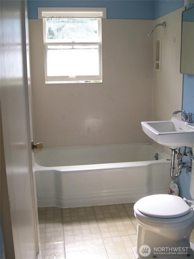 full bath featuring toilet, shower / bath combination, and a sink
