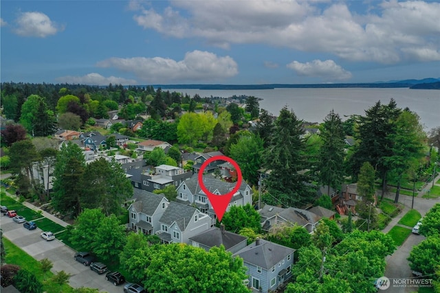 aerial view of residential area featuring a large body of water