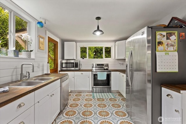 304 Riverview Dr NE, Auburn, WA 98002 - kitchen featuring appliances with stainless steel finishes, a sink, butcher block countertops, and white cabinets