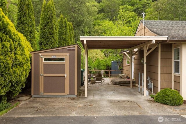 304 Riverview Dr NE, Auburn, WA 98002 - view of vehicle parking with a storage shed, a carport, fence, and a view of trees