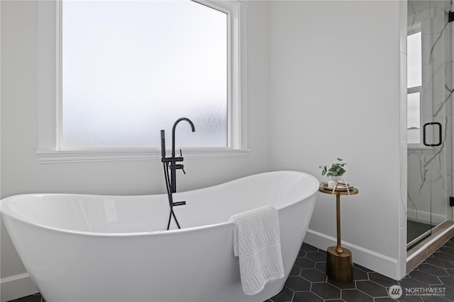 full bath with a marble finish shower, baseboards, tile patterned flooring, and a freestanding bath
