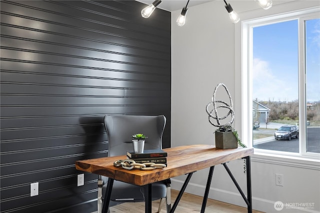 office with light wood-style floors and baseboards