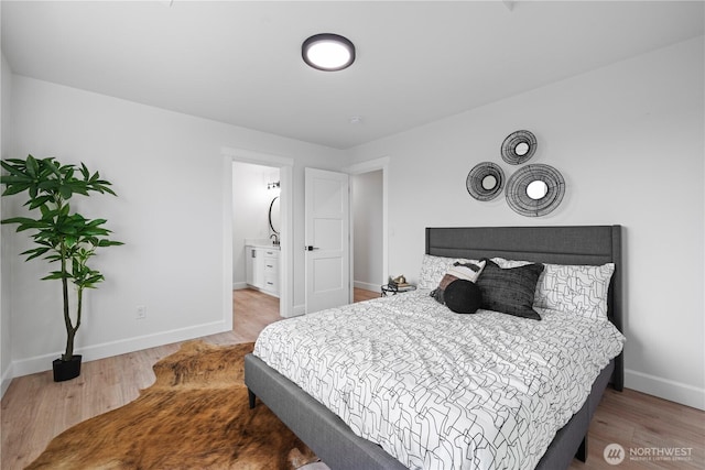 bedroom featuring wood finished floors and baseboards
