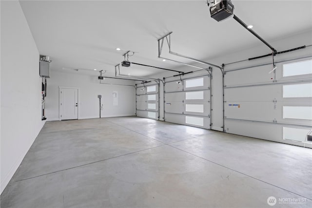garage featuring a garage door opener and baseboards