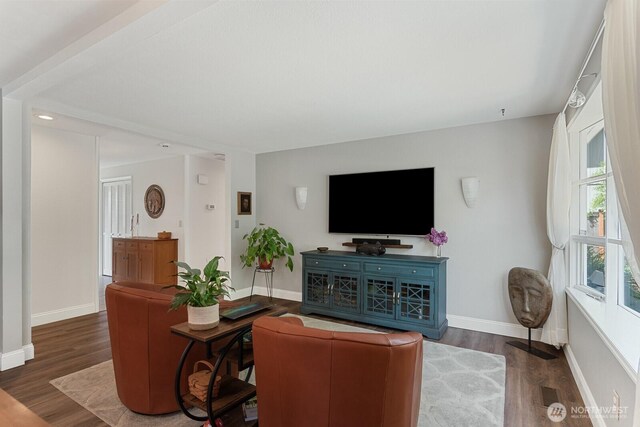 living area featuring wood finished floors and baseboards