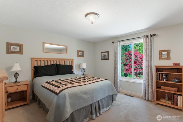 bedroom featuring carpet floors and baseboards
