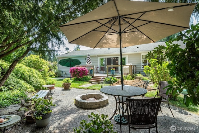view of patio featuring a fire pit and a wooden deck
