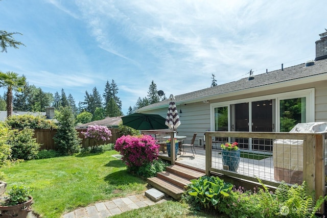 back of house with a wooden deck and outdoor dining space