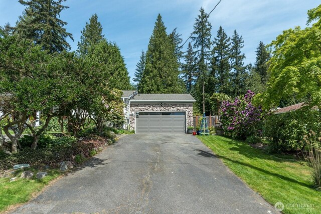 garage featuring asphalt driveway