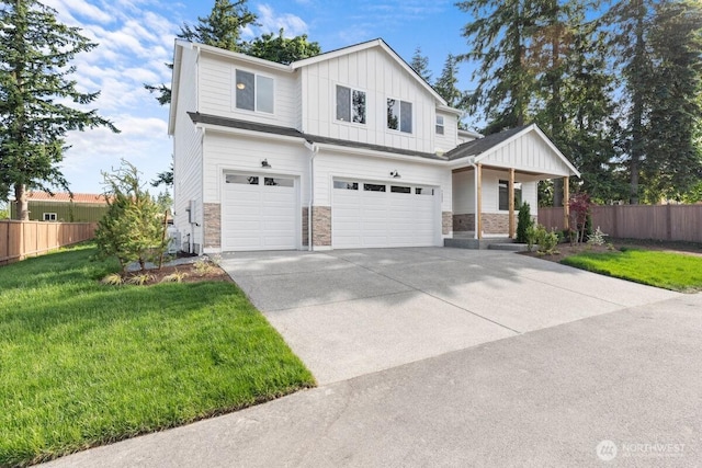 7332 284th St NW, Stanwood, WA 98292 - view of front of house with a garage, stone siding, board and batten siding, and concrete driveway