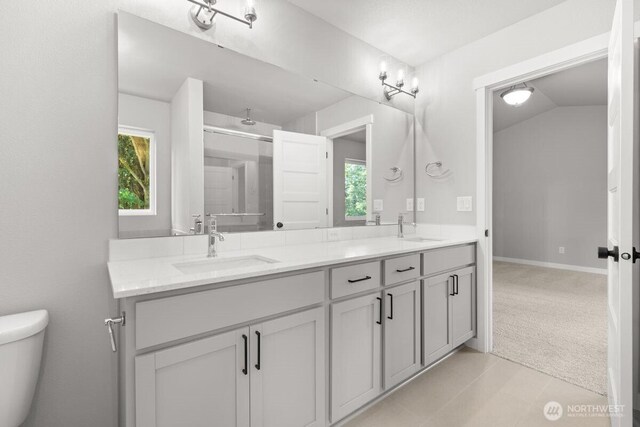 7332 284th St NW, Stanwood, WA 98292 - full bathroom featuring double vanity, healthy amount of natural light, lofted ceiling, and a shower