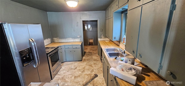 202 W 2nd Ave, Odessa, WA 99159 - kitchen featuring appliances with stainless steel finishes, a sink, and gray cabinets