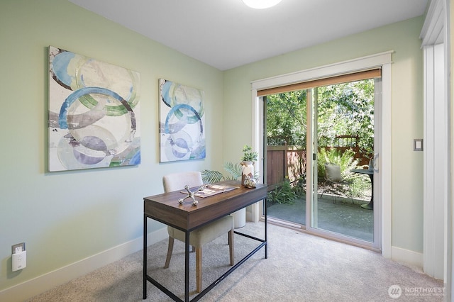 carpeted home office featuring baseboards