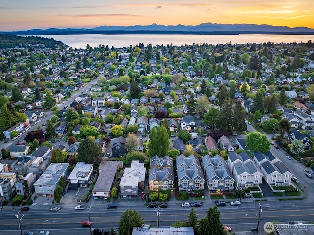 aerial view at dusk of a water and mountain view and a residential view