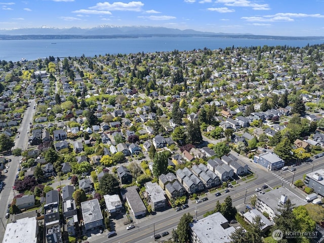 view of property location with a water and mountain view and nearby suburban area