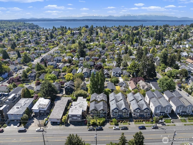 aerial view of residential area featuring a water and mountain view