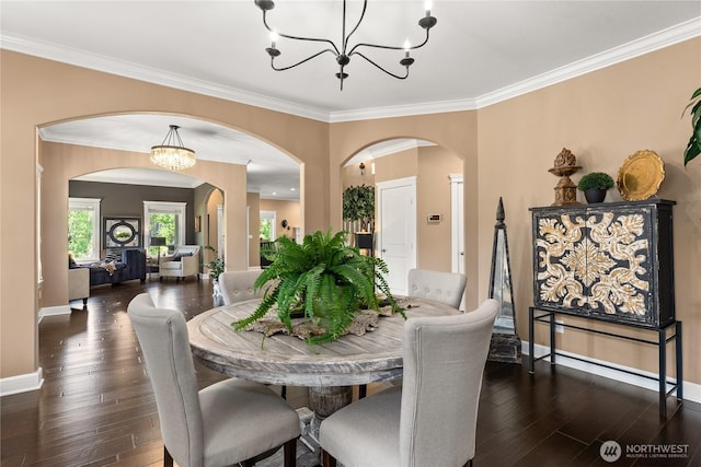 3237 Gravelly Beach Loop NW, Olympia, WA 98502 - dining room with a chandelier, arched walkways, crown molding, and dark wood-type flooring