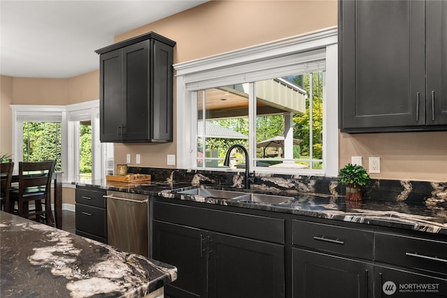 3237 Gravelly Beach Loop NW, Olympia, WA 98502 - kitchen with a sink, stainless steel dishwasher, dark cabinets, dark stone counters, and healthy amount of natural light