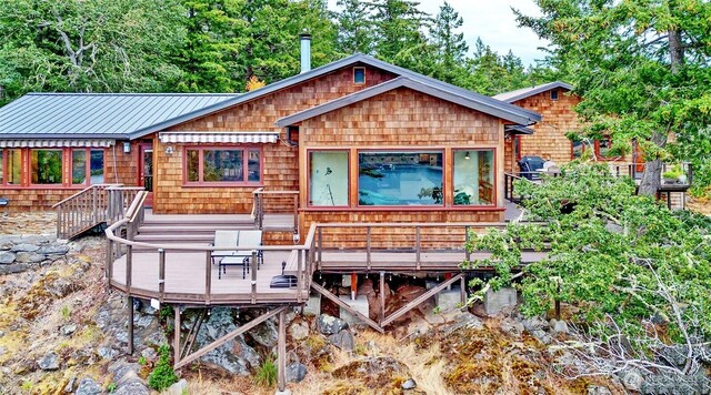 rear view of property with a wooden deck