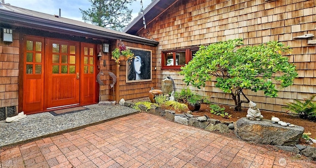 view of exterior entry featuring a patio area