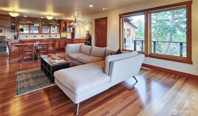 living room featuring dark wood-style flooring, recessed lighting, and baseboards