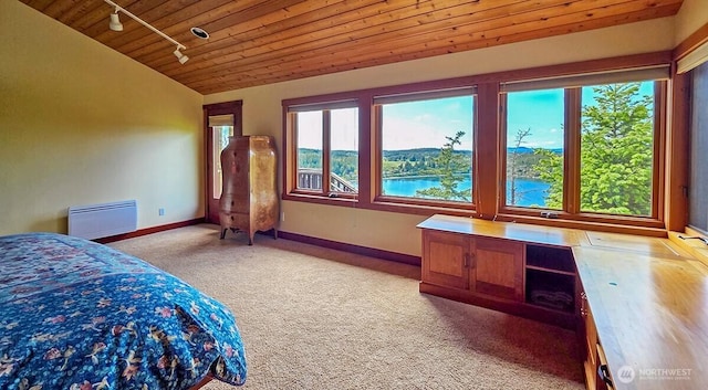 bedroom with wooden ceiling, track lighting, light colored carpet, baseboards, and vaulted ceiling