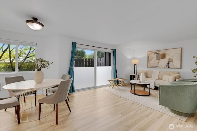 living area with healthy amount of natural light and light wood-style flooring