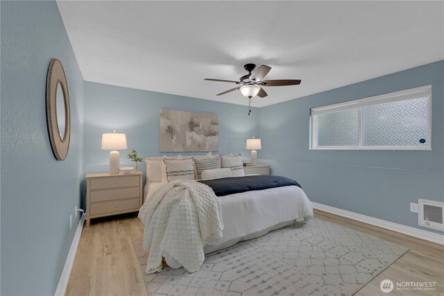 bedroom with baseboards, light wood-style flooring, and ceiling fan