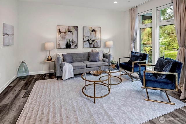 living area featuring wood finished floors, baseboards, and recessed lighting