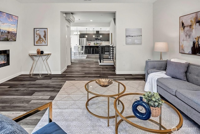 living area with dark wood-type flooring and baseboards