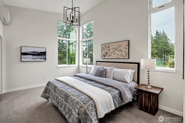 carpeted bedroom with a wall unit AC, a chandelier, multiple windows, and baseboards