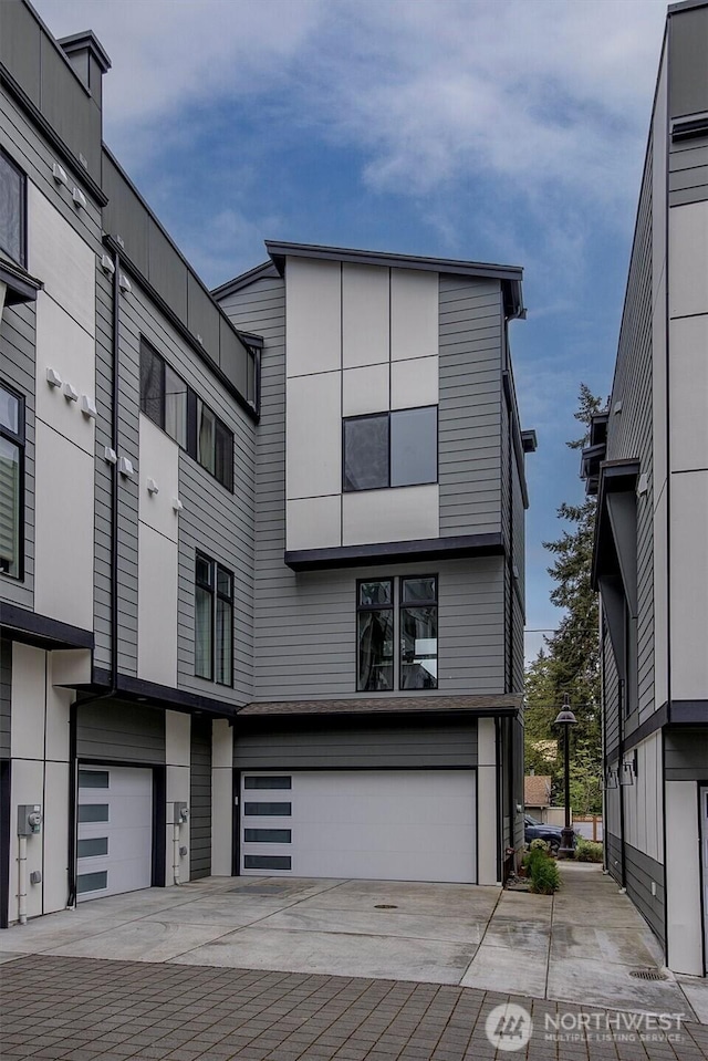 contemporary home featuring a garage and concrete driveway